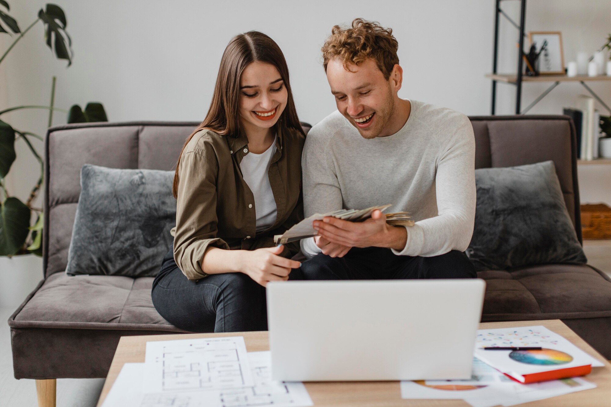 Difference Between Short Sale, Pre-Foreclosure and Foreclosure Properties happy couple making plans to remodel the home together