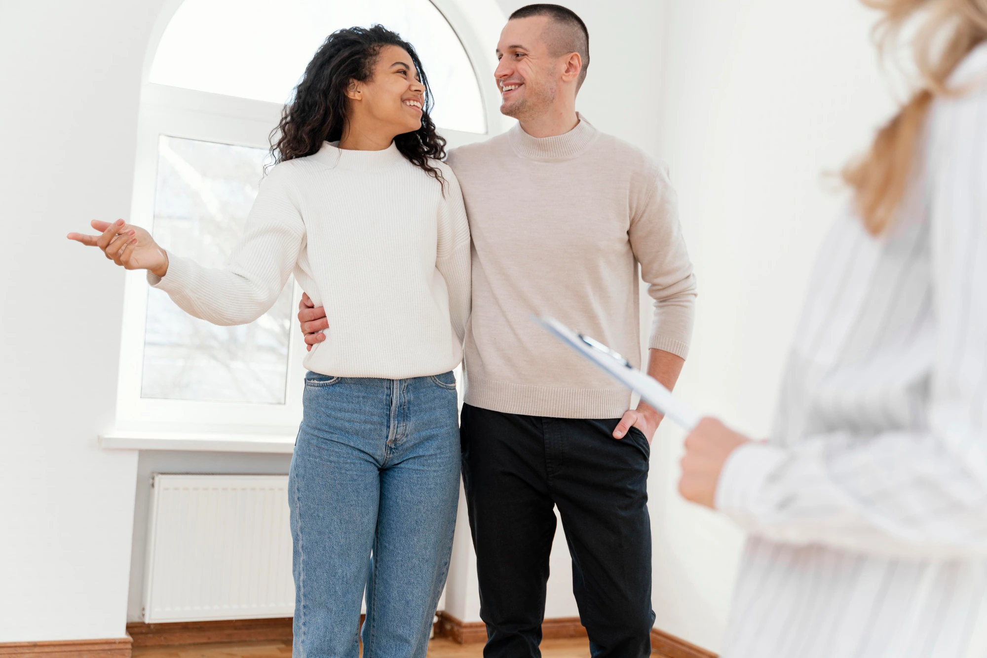 Best Websites for Foreclosure Listings smiley couple seeing new house with female realtor